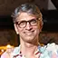 a photo of a happy male dance student with glasses and long grey hair